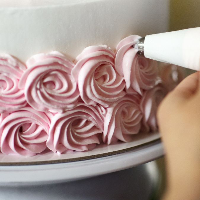 Decoration of barbie cake with buttercream form of flowers