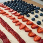 close up shot of a piece of the American flag cake with strawberry and blueberry