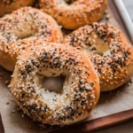 Freshly baked everything bagels made from a high protein bagel recipe with Greek yogurt, topped with sesame and poppy seeds.