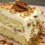 close up shot of the Italian cream cake piece with shopped pecans