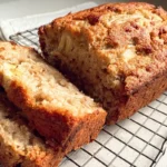 Sliced cottage cheese banana bread on a cooling rack, showcasing its moist and tender crumb.
