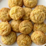 A photo featuring a plate of golden-brown, freshly baked cookies. The cookies are evenly baked, with a golden-brown crust of potato chip