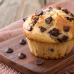 kodiak muffin with chocolate chip on wooden plate