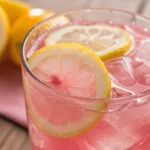 pink lemonade with lemon in a glass