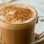 pumpkin chai latte in a cup with cannel for christmas and fall