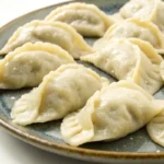 homemade dumplings recipe on a plate with chicken