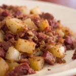 corned beef hash with potato and onion on plate