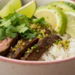 Cilantro Lime Steak Bowls with sliced steak, rice, fresh vegetables, and bright cilantro lime seasoning served as a healthy steak bowl meal.