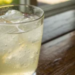 Homemade electrolyte drink in a glass with citrus and fresh ingredients shown as a natural hydration drink recipe.