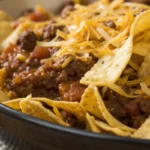 Frito Pie Recipe with layers of seasoned beef, crispy corn chips, and melted cheese served hot as a comforting casserole style dish.