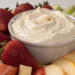 Fruit dip served in a bowl surrounded by fresh fruit, featuring a creamy cream cheese fruit dip recipe perfect for sweet dips for parties and fruit tray ideas for party spreads.
