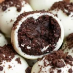 Oreo balls coated in chocolate on a serving plate, featuring Oreo cookie balls made with a simple Oreo ball recipe and perfect as easy dessert balls.