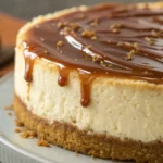 Salted Caramel Cheesecake Recipe with a creamy cheesecake base topped with glossy salted caramel sauce and a smooth baked texture.