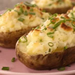 Twice baked potatoes filled with a creamy cheesy potato mixture, baked until golden and served as loaded baked potatoes or double stuffed baked potatoes for an easy side dish.