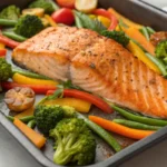 Sheet pan salmon baked with fresh vegetables on a single tray, a healthy and easy salmon dinner idea inspired by healthy sheet pan dinners and simple salmon dinner recipes