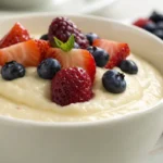 Creamy cottage cheese pudding blended until smooth and topped with fruits or peanut butter, served as a healthy high protein dessert in a small bowl