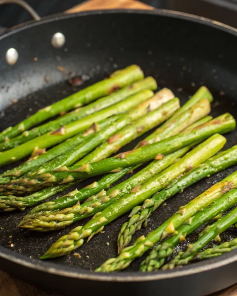 Asparagus stir frying in a pan with garlic. Shrimp and Asparagus Stir Fry