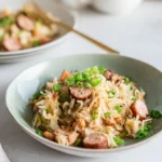 Sauerkraut & Sausage One-Pan Skillet with golden browned kielbasa and caramelized onions on a rustic plate