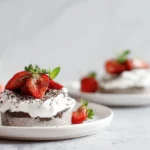 Chia Seed Pudding Parfait layered with fresh berries and granola in a clear glass on a white plate