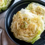 Fermented Cabbage Steak (Air Fryer) with crispy golden edges on a white plate garnished with fresh parsley