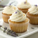Honey Lavender Cupcakes with swirled honey buttercream frosting topped with lavender buds on a white marble serving plate