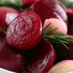 Pickled beets recipe featuring ruby red beet slices in a clear glass jar with spices