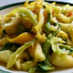 Banana pepper recipe featuring golden yellow pickled pepper rings in a white bowl with visible brine
