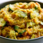 Zucchini relish in a glass jar with a spoon, showcasing sweet and tangy homemade condiment