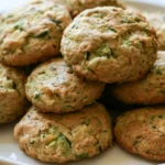 Zucchini cookies stacked on a white plate showing soft texture and chocolate chips