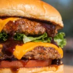 Blackstone smash burger with melted cheese and crispy edges on a toasted bun with lettuce and tomato