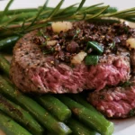 Blackstone steak recipe showing perfectly seared ribeye with golden crust and melted garlic butter on white plate