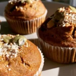 Pumpkin protein muffins arranged on a white plate with visible golden tops and tender crumb texture
