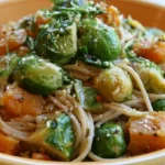 Brussels Sprouts, Butternut Squash Pasta plated in a white bowl with caramelized vegetables and sage leaves