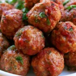 Marry me meatballs in creamy sun-dried tomato sauce served on a white plate with fresh basil garnish