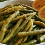 Dilly beans recipe showing crispy pickled green beans in a glass jar with fresh dill and garlic cloves