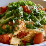 Chicken Cottage Cheese Enchilada Bowls with rice, creamy sauce, melted cheese and cilantro in a white bowl