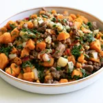Beef sweet potato hash served in a skillet with golden caramelized edges and fresh parsley garnish
