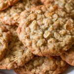 Oatmeal cookie recipe with chewy centers and crisp edges stacked on a white plate