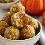 Pumpkin protein balls arranged on a white plate with fall spices scattered around