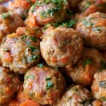 Albondigas in a white bowl with meatballs, carrots, zucchini, and tomato broth, garnished with fresh cilantro