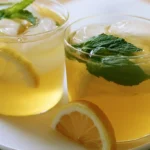 Honey citrus mint tea in a clear glass mug with lemon slices and fresh mint leaves