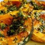 Roasted kabocha squash wedges on a white plate with golden caramelized edges and creamy orange flesh